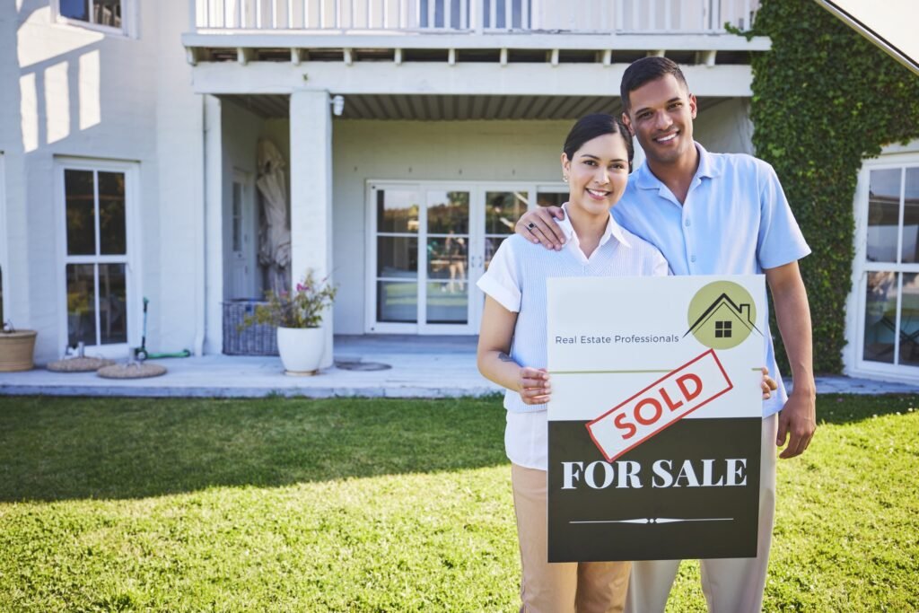 New home, sold sign and happy couple portrait for house, real estate and property purchase, sale or